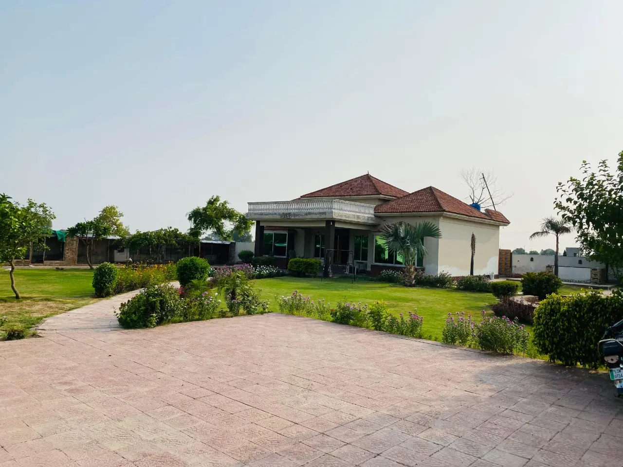 Paved driveway and landscaped garden leading to the farmhouse villa
